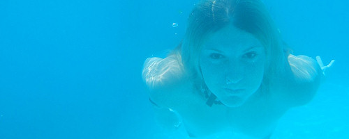 Teen girl swimming in the pool